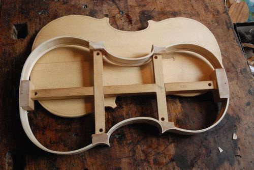 Das Innere und eine Außenseite einer Geige auf einem Holztisch